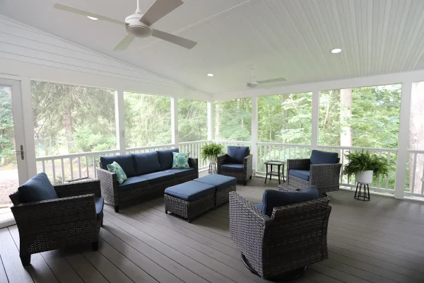 screened porch with couches and fan