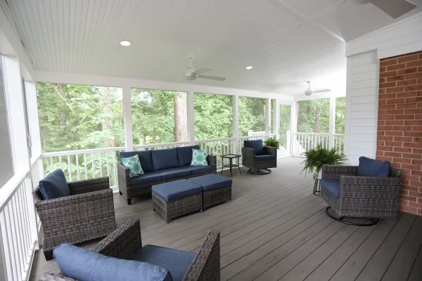screened porch with couches and chairs