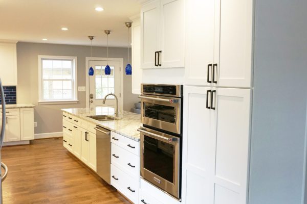 blue and white kitchen cabinets and oven