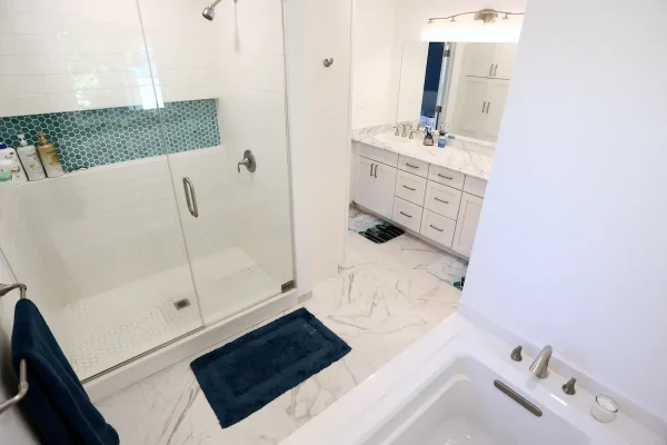bathroom with shower and bathtub