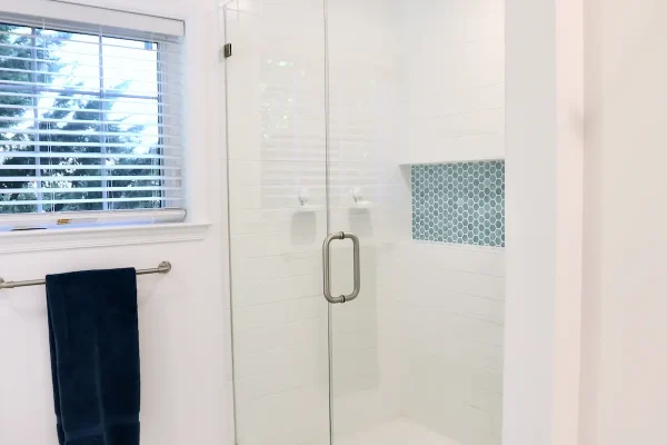 white bathroom with glass shower door