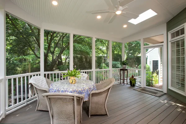 screened porch with table and chairs