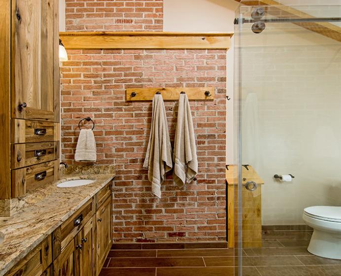 bathroom with brick wall