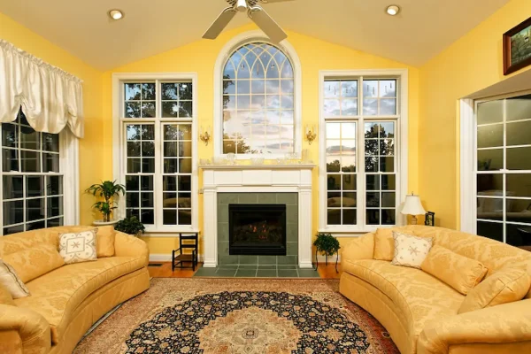 living room with yellow walls and green fireplace