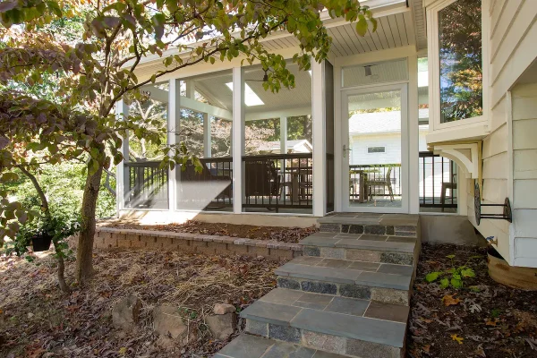 spacious screened porch with stone stairs