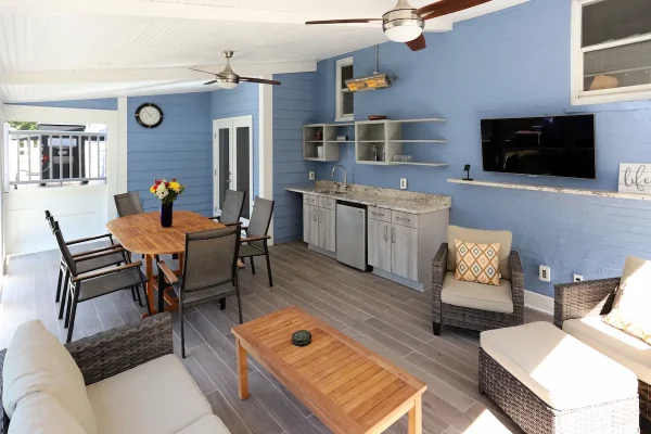 vibrant blue screened porch with kitchen