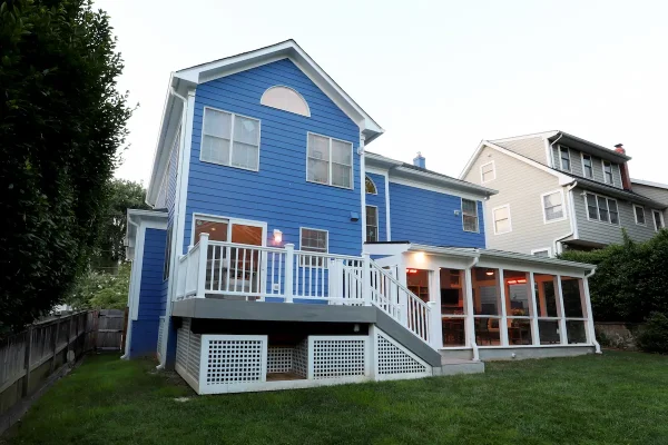 vibrant blue house with screened porch